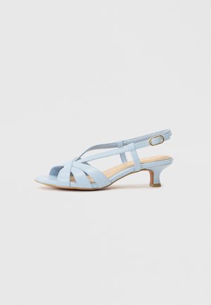 Light blue leather slingback sandal with multiple cross straps, open toe, and a low, curved heel. Features an adjustable ankle strap.