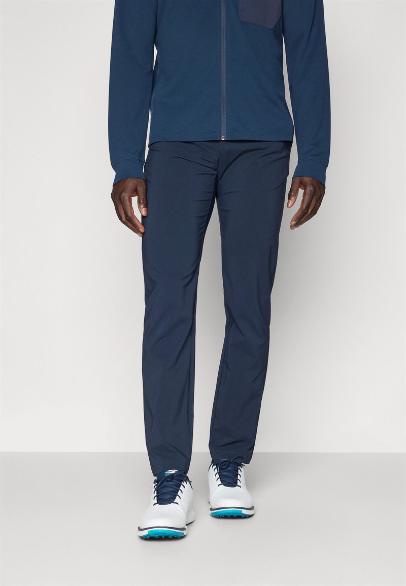 Navy blue athletic pants with a slim fit, crafted from lightweight material. Features a smooth texture and no visible patterns or accents.