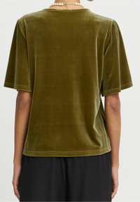 T-shirt in velluto verde oliva con maniche corte, scollatura rotonda e una texture liscia. L'orlo è dritto con sottili dettagli di cucitura.