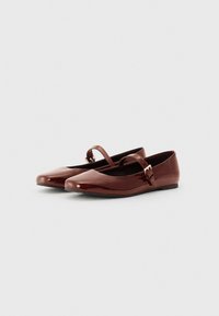 Brown patent leather ballet flats with a square toe, featuring a small adjustable strap and a gold-tone buckle accent. Flat sole design.