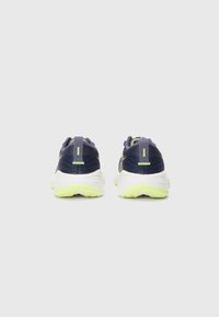 Navy and grey athletic shoes with green accents; mesh upper, cushioned white sole, and reflective detailing on the heel and sides.