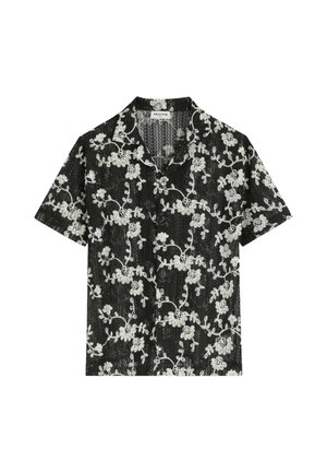 Chemise noire à manches courtes avec boutons, motif en dentelle florale blanche et col.