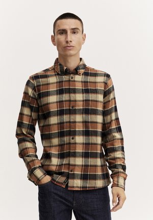 Plaid flannel shirt in beige, orange, and navy. Button-down collar, long sleeves, features chest pocket and subtle branding detail.
