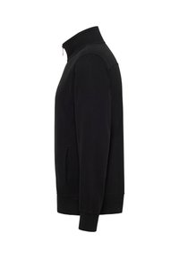 Veste noire à manches longues avec fermeture éclair, col montant, poches latérales et poignets côtelés, vue de profil droit sur fond blanc.