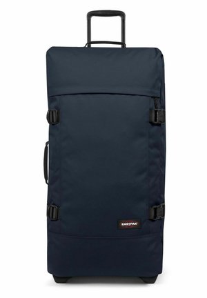 Bolsa de viaje de color azul marino con un tejido duradero, asa superior y cierres de hebilla. Exterior liso con un parche de logo en la parte inferior.