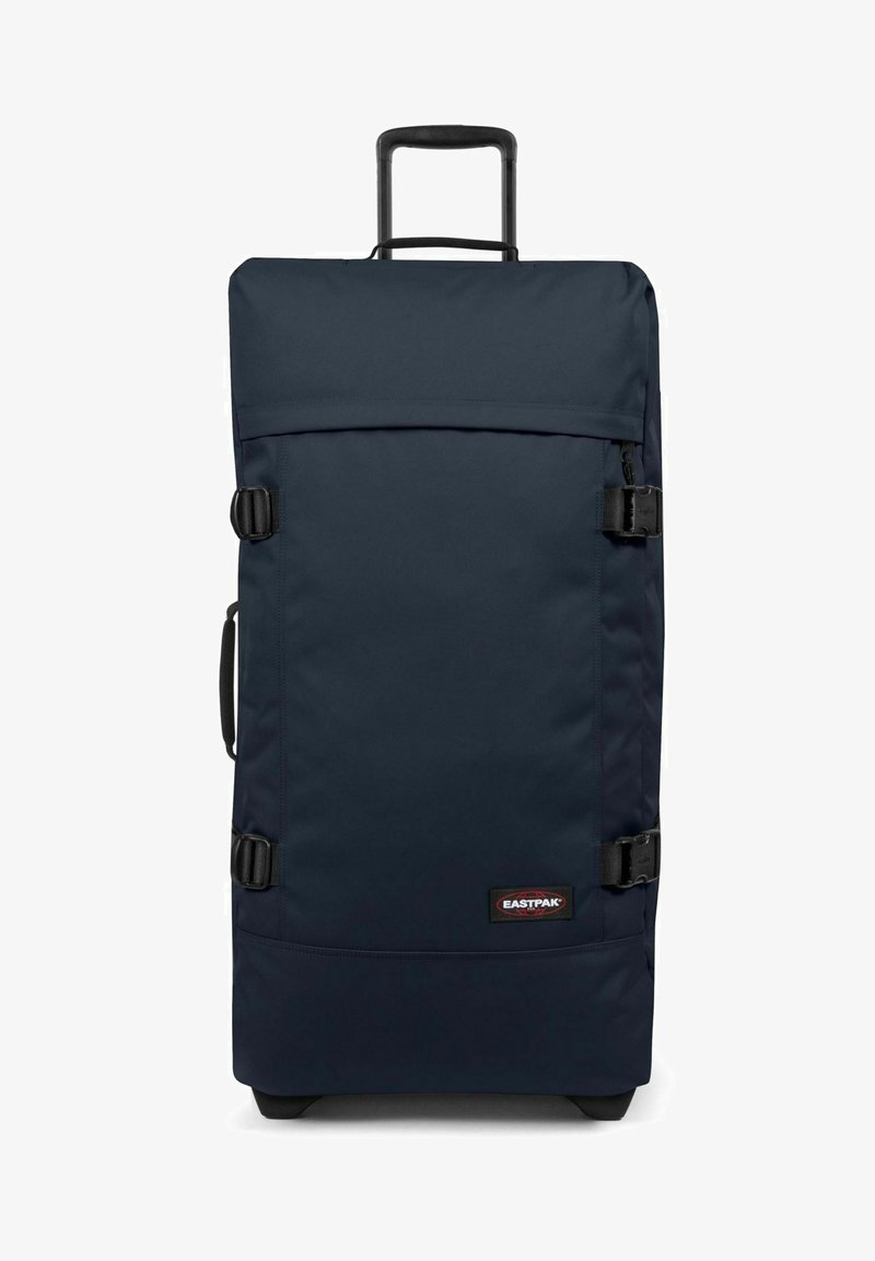 Sac de voyage bleu marine avec un tissu résistant, poignée supérieure et fermetures à boucles. Extérieur uni avec un patch logo en bas.