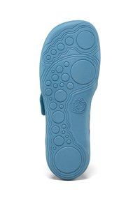 Light blue rubber shoe sole featuring a textured surface with circular and wavy patterns, along with an embossed logo detail.