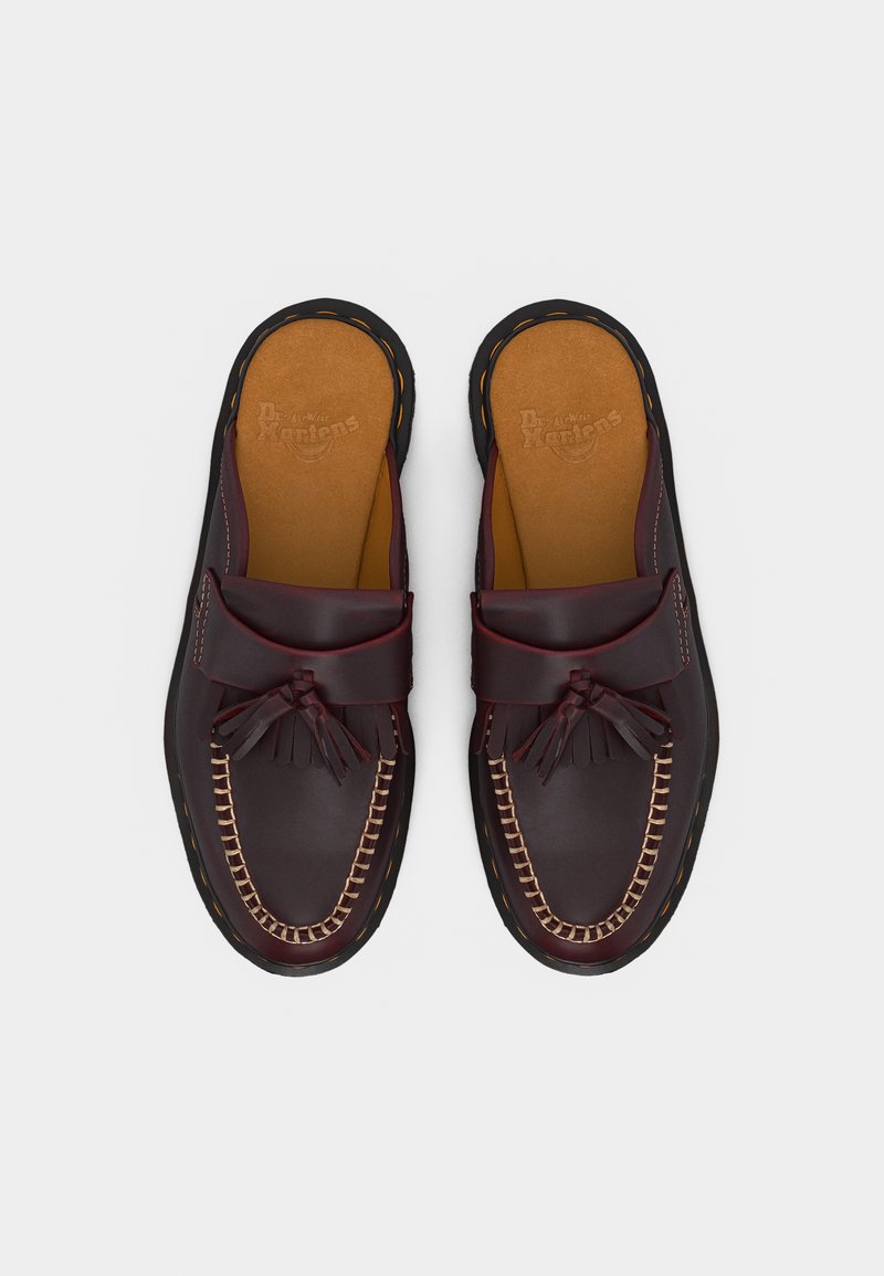 Paar dunkelburgunderfarbener Leder-Slipper mit Quasten, beiger Naht und gepolsterten hellbraunen Innensohlen.