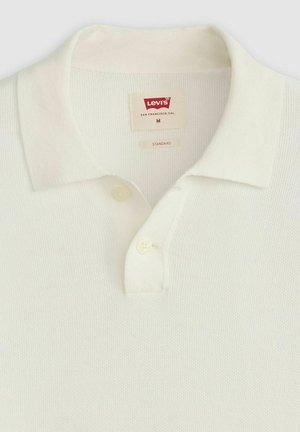 Polo shirt bianco a maniche corte in un tessuto testurizzato, con colletto classico, patta con due bottoni e etichetta Levi's. Taglia M.