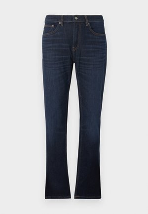 Σκούρο μπλε τζιν παντελόνι με ίσια γραμμή, διακοσμημένο με πορτοκαλί ραφές, πέντε τσέπες και κλείσιμο με φερμουάρ.