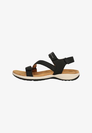 Sort sandal med justerbart stropdesign, blød korklignende fodseng og en polstret hvid mellemsål med en tekstureret gummisål.