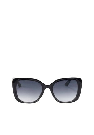 Gafas de sol cuadradas negras de gran tamaño con lentes degradadas de gris oscuro a claro y monturas gruesas.