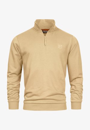 Beige zipkraag trui met lange mouwen, voorzien van ribgebreide boorden en zoom. Zachte textuur en subtiele logo-detail op de borst.