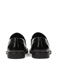 Black leather dress shoes with a high-gloss finish, rounded toe, and low heel, featuring subtle stitching and a smooth texture.