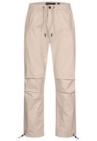 Lys beige cargo bukser med elastisk talje, justerbar snor og lynlåse nederst på benene. Glat stof med sidelommer.