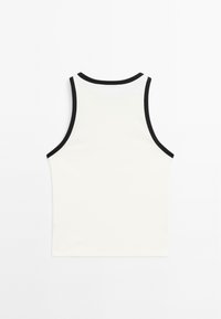 White tank top with black trim around the neck and armholes. Simple design, made from a smooth fabric, with a fitted shape.
