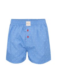 Boxer in cotone blu con pois bianchi, con elastico in vita e due bottoni rossi sul davanti. Etichetta visibile vicino all'elastico.