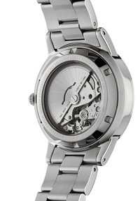 Montre en acier inoxydable avec un fond de boîte transparent révélant le mouvement automatique. Elle possède une finition polie et un bracelet à maillons solides.