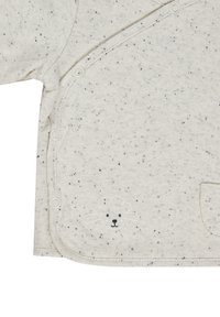 Oberteil aus Baumwollmix, hellgrau mit schwarzen Sprenkeln. Verfügt über Druckknopfverschlüsse und ein gesticktes Schafmotiv auf der Vorderseite. Abgerundeter Saum.