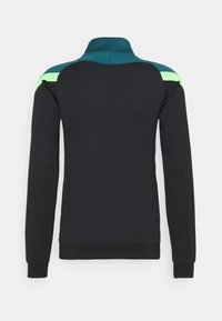 Veste noire à manches longues avec un col montant, comportant des accents verts et bleu sarcelle sur les épaules et un tissu lisse et texturé.
