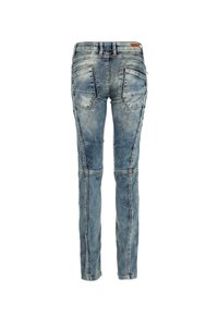 Jeans de mezclilla azul con un acabado desgastado, corte ajustado, dos bolsillos traseros, costuras distintivas y detalles en el panel de la rodilla. Se muestra la vista trasera.