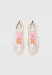 Light gray sneakers with silver accents, featuring pink and orange laces, suede and synthetic materials, and a minimalist design.