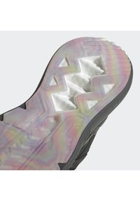 Shoe sole features a translucent, multicolored rubber design with a textured surface and angular tread pattern for traction. Black accents are visible.