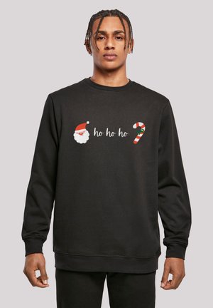 Black sweatshirt with long sleeves featuring a Santa face, text "ho ho ho," and a candy cane graphic. Made of soft fabric, casual fit.