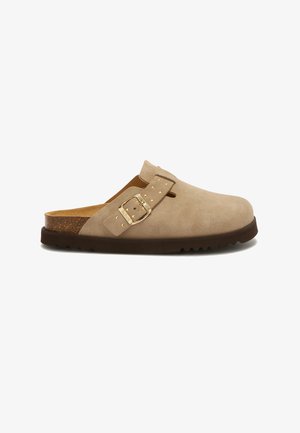 Beige suede slip-on clog with adjustable gold buckle, cork footbed, and dark brown rubber sole.