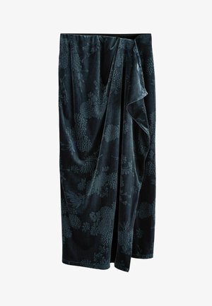 Dark green velvet skirt featuring a floral pattern, with a soft texture and a draped design, creating an elegant silhouette.