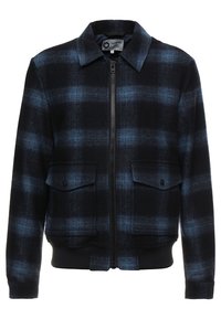 Giacca a quadri nera e blu con zip frontale, due tasche con patta sul petto e polsini e orlo a coste. Realizzata in tessuto intrecciato.