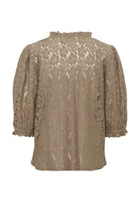Krajková blůza v tlumené béžové barvě s bouffant rukávy a volánovým límcem. Obsahuje složité květinové vzory po celé látce.