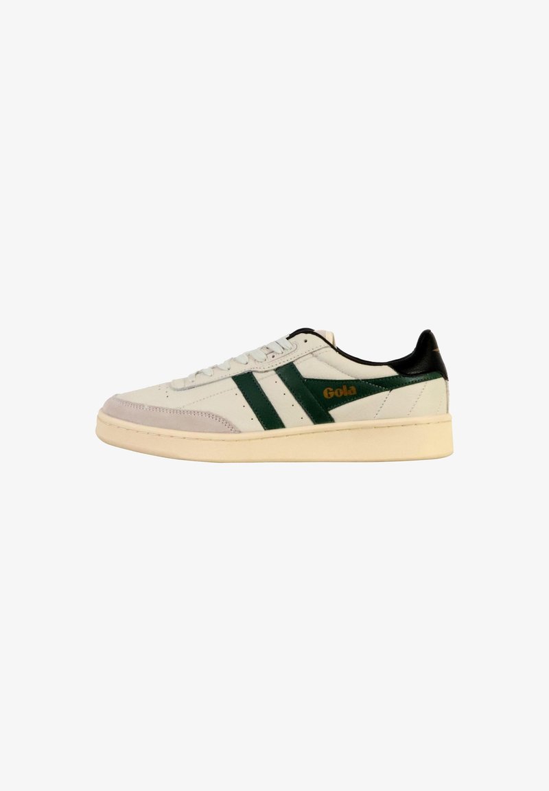 White low-top sneaker with dark green side stripes, black heel tab, beige sole, and "Gola" logo in gold on the side.