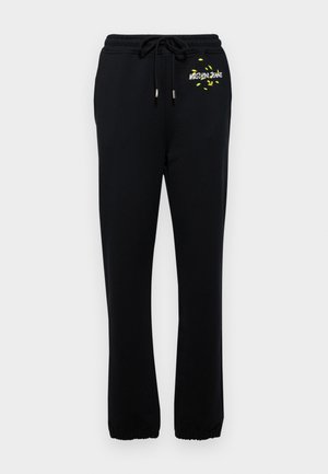 Pantaloni della tuta neri con vita elastica e cordoncino, dotati di una piccola grafica gialla e polsini elastici alle caviglie.