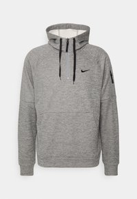 Haut à capuche gris avec une fermeture éclair sur le devant, des manches raglan, une poche avant et un petit logo noir. Doté de cordons de serrage noirs et d'une texture intérieure douce.