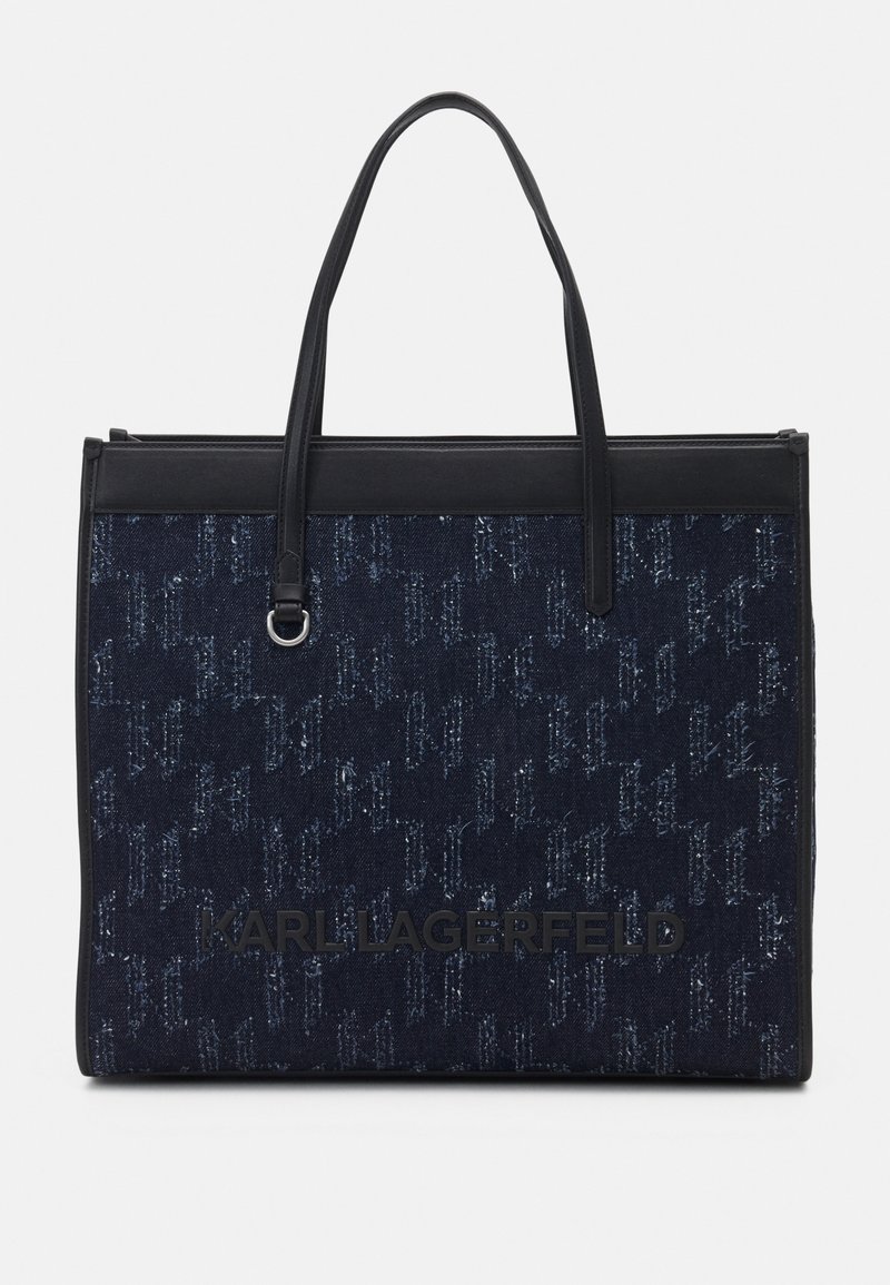 Sac cabas en denim bleu foncé avec poignées noires, bordure noire et logo "KARL LAGERFELD" sur le panneau avant.
