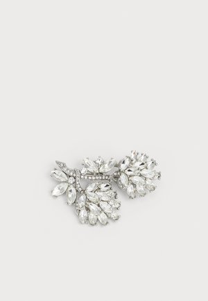 Rhinestone brooch featuring an intricate design with marquise and round cut clear crystals set in silver-toned metal, resembling floral branches.