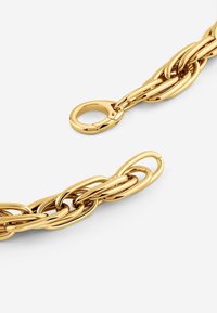 Gold metal chain bracelet with interlinked oval shapes, featuring a lobster clasp closure. Smooth, shiny texture with polished finish.