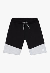 Mustat verkkarihousut, joissa on harmaa alaosa, joustava vyötärönauha ja kiristysnyöri, jossa on painettu brändäys; pehmeä kangaspinta.