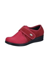 Red shoe with a textured upper in mesh and suede, Velcro strap for adjustment, rounded toe, and a low wedge black sole.