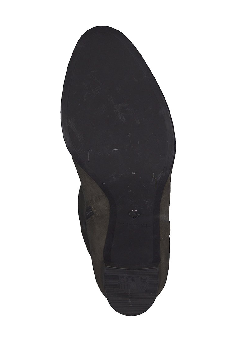 Semelle d'une chaussure habillée noire avec un dessous en cuir lisse et un talon en caoutchouc étiqueté "ANTI GLISSE".