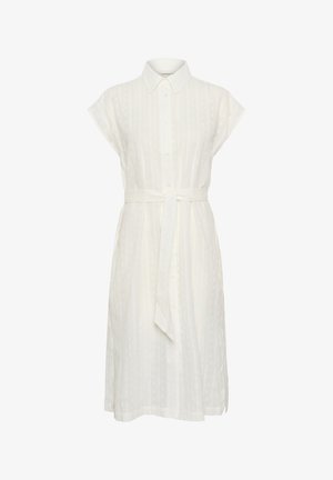 Valge särk-kleit, millel on kraega kaelus, lühikesed varrukad ja seotud talje. Omab peeneid vertikaalseid triibe ja nööbivarrukat.