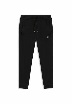 Schwarze Jogginghose aus weichem Stoff mit elastischem Bund, verstellbarem Kordelzug und seitlichen Taschen. Verfügt über ein kleines Logo-Detail.