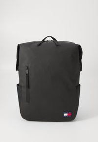 Svart ryggsekk med rull-topp design, glidelåslomme foran, sidelomme i mesh og et lite logo-patch nederst. Vanntett materiale.