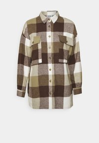 Ruutukuosiset flanellipaita ruskean ja oliivinvihreän sävyissä, pitkät hihat, kaksi etutaskua ja kuusi nappia edessä; pehmeä kangas, rento malli.