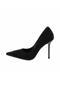 Stivale con tacco a spillo in suede nero a punta, con dettaglio testurizzato sulla punta, design elegante e tacco sottile sotto una luce intensa.