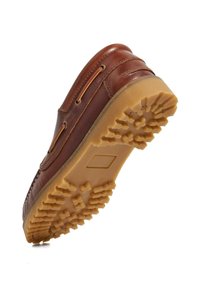 Brown leather shoe with a textured rubber sole featuring a pattern of raised, geometric shapes. Visible stitching and eyelets for laces.