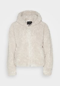 Veste à capuche duveteuse de couleur crème avec fermeture éclair complète à l'avant, manches longues et tissu à texture douce.