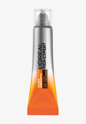 Crème contour des yeux L'Oréal Men Expert dans un tube argenté avec une base dégradée orange. Présente un embout cylindrique avec un capuchon transparent. Texte imprimé sur le côté.