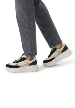 Chunky sneakers featuring a black, beige, and metallic gold design, with a textured upper and elevated white sole.